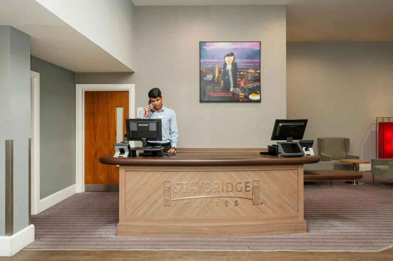 Guest at the lobby desk of the Birmingham aparthotel